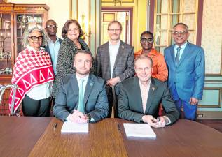 Standing, Dr. Wartyna Davis, WPU Dean of the College of Arts, Humanities and Social Sciences; Dr. Anthony Bowrin, WPU Dean of the Cotsakos College of Business; Nancy Gallo, SCCC Associate Vice-President of Academic Affairs; Dr. Josh Powers, WPU Provost; Dr. Djanna Hill, WPU Associate Dean of the College of Arts, Humanities and Social Sciences; and Dr. Venkat Sharma, WPU Dean of the College of Science and Health; seated: Dr. Cory Homer, SCCC President, and Dr. Richard Helldobler, WPU President.