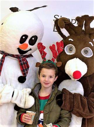 PHOTOS BY VIKTORIA-LEIGH WAGNER Lucas Barbarise snuggles up to Frosty the Snowman and Rudolph the Red Nosed Reindeer at the Simply Dance Holiday Showcase Dec. 4.