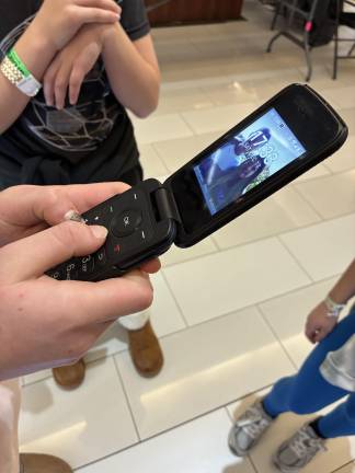 Tweens hanging out at the Galleria mall. The retro flip phone has been seeing a resurgence over the past few years.