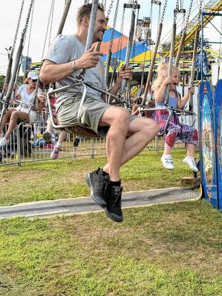 <b>Fair-goers ride the swings Saturday, Aug. 2. (Photo by Denise von Wilke)</b>