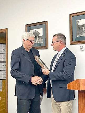 Hamburg Mayor Paul Marino, left, who has held that post for 22 years, receives a plaque from his successor, Richard Krasnomowitz, at the Dec. 5 meeting of the mayor and council. Marino did not run for re-election. Krasnomowitz will be sworn in at the annual reorganization meeting Jan. 4. (Photo provided)