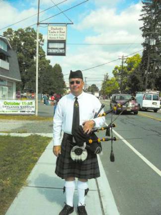 Photos by Don Carswell Ken O'Brien, a bagpiper from the Rory O'Moore group, sports a kilt for the parade.
