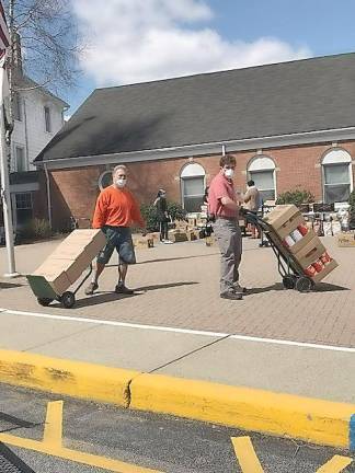 Volunteers with the Sparta Ecumenical Food Pantry distribute food (Photo provided)