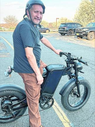 <b>Miguel Ceballos of Newton poses on his e-bike.</b>