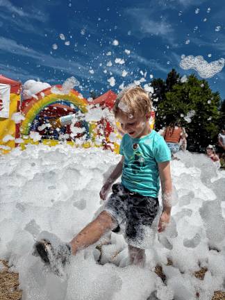 <b>Clark Hornblower, 4, of Newark plays in foam at the fair. (Photo provided)</b>