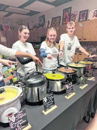 Hailey Phillips, Destiny Cerracchio and Michael Gibson point at their favorite soup.