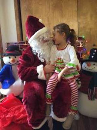 Shanti shares a secret with Santa.