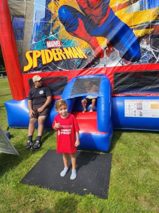 HD2 Logan Arxer, 7, of Hamburg stands in front of a bounce house with a slide at the Hamburg Day celebration.