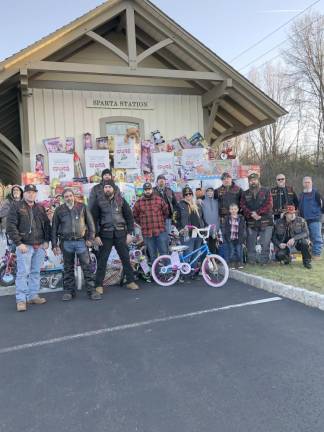 Members of the Warlocks motorcycle club, based in Hardyston, pose with donated toys awaiting Operation Toy Train at the Sparta Station.