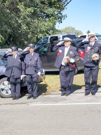 Franklin Borough Councilmember Joe Limon and others salute the Flag.