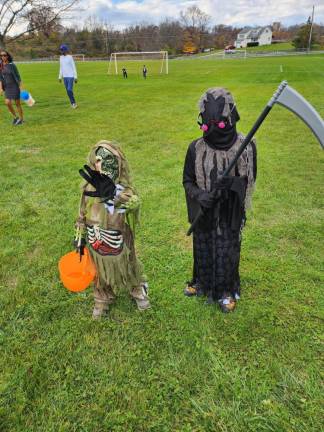 Lorenzo Magarino, 4, is dressed as a zombie and Gino Magarino, 7, is the Grim Reaper.