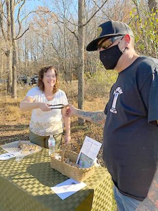 Kelly Salerno gives a cookie sample to Mike Muery, who just moved into the area (Photo by Laurie Gordon)