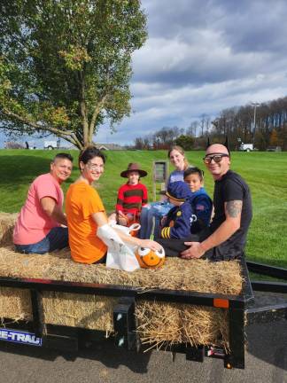 On the hayride, from left, are Fernando Neftaly, Stephanie Suckey, Mike Suckey, Logan Suckey on lap, Wesley Meyer, Heather Meyer and Lilly Meyer. The Halloween Spooktacular also offered face painting, a dance performance and a pumpkin give-away.