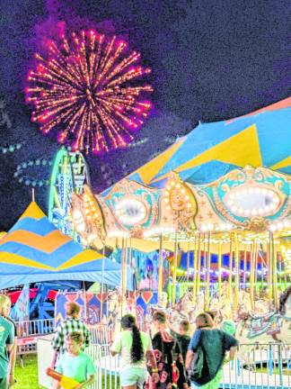 <b>Fireworks lit up the midway after dark.</b>