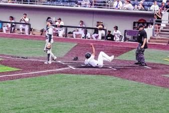 <b>In the fifth inning of the Sussex County Miners’ game against the Québec Capitales on June 13, Dom Johnson of the Miners slides safe across home plate to increase his team’s lead to 3-0. The Miners won, 6-0. (Photos by George Leroy Hunter)</b>