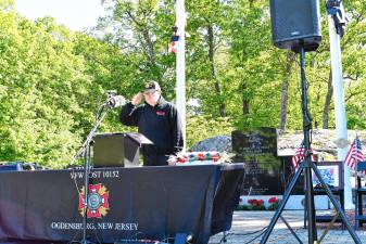 Retired Police Chief George Lott, Memorial Day chairman, salutes during the service Monday, May 26 at Ogdensburg Memorial Park at Heaters Pond. Lt. Robert A. Madden Veterans of Foreign Wars Post 10152 of Ogdensburg has held a Memorial Day service since it was formed in 1968. (Photos by Maria Kovic)