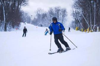Skiers take to the slopes on Sunday, Dec. 18, opening day of the season at Mountain Creek Resort in Vernon.