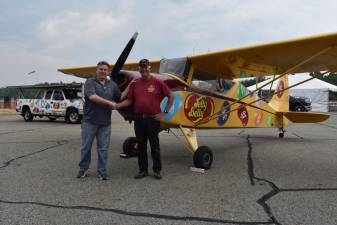 Tim Wagner, left, Greenwood Lake Air Show chairman, shakes hands with Kent Pietsch, who is making his debut performance at the 2023 event. They are standing by Pietsch’s 1940 vintage 800-pound interstate Cadet aircraft in which he performs his renown aerobatic routines. (Photos by Rich Adamonis)