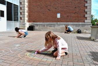 Children use chalk to decorate the entry to Ogdensburg Elementary School on Monday, Sept. 1. School started for the fall with a half-day Tuesday, Sept. 2. (Photos by Maria Kovic)