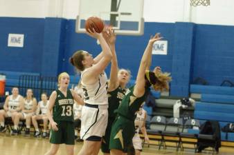 Pope John's Patrice Kali attempts a shot while double teamed. Kali scored six points, grabbed six rebounds and blocked one shot. Photos by George Leroy Hunter