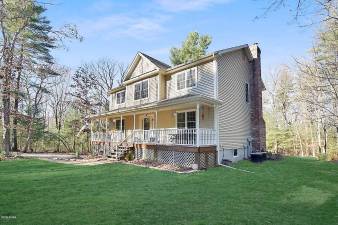 Farmhouse-style four-bedroom home has lake access