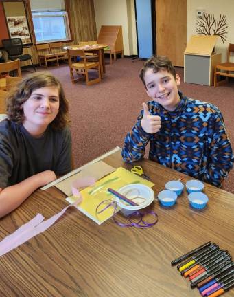 From left, Sean Staab, 12, of Wantage and Travis Dorne, 13, of Vernon pose with materials they could use in the Egg Drop Challenge.