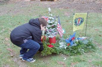 Justin honors his grandpa by placing a wreath.