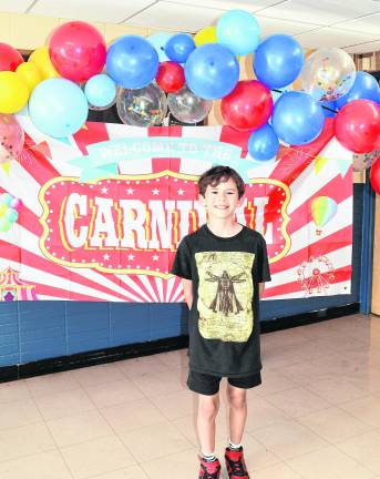 Gavin Sure poses in front of the sign.