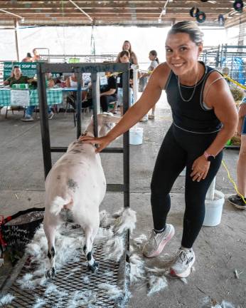 <b>Devon Garrity with a newly shorn goat Saturday, Aug. 2. (Photo by Nancy Madacsi)</b>
