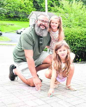 Scott, Hanah and Harper Weiland pose for a photo.