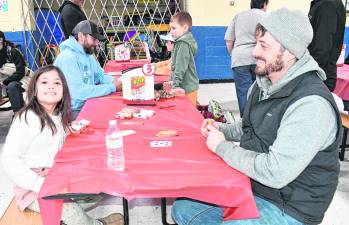 Anna Vinales and her father, Don, play cards.