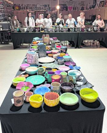 Hailey Phillips, Destiny Cerracchio, Michael Gibson and Adrianna Romeo stand behind the soup bowls.