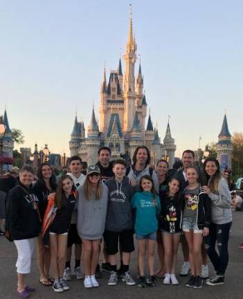 The Viscel family poses at a Disney theme park.