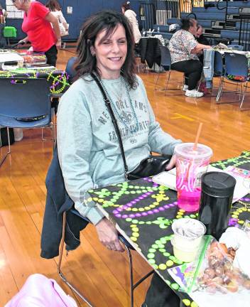 Cindy Clegg of Stockholm sits at a table.