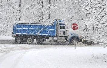A snow plow heads north on Route 23.