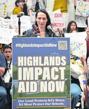 Sara Fasano is the co-founder of Highlands Impact Aid Now and organizer of the rally with husband, Tom (right), seated next to daughter Lily.