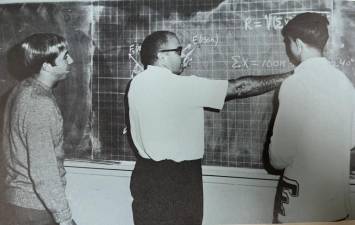Howard Charles Bach Jr. informs Henry Deluca, left, and Ron Szanyi, about tensors and vectors in a physics class at Franklin High School in 1969. (Photo provided)