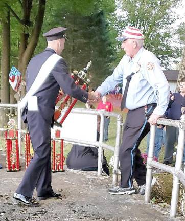 Khyle Conklin, Franklin Borough Assistant Chief, congratulates and gives out a winner’s trophy at the parade.