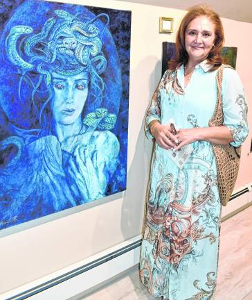 Rima Hamade of Sparta stands in front of a painting.