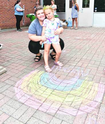 Megan and Abigail Guarducci of Ogdensburg pose next to a picture of a rainbow.