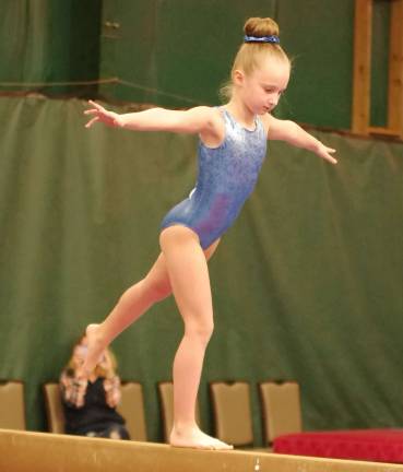Westys Gymnastics (Franklin Borough, N.J.) athlete HANNAH POTZER (7) performs on the balance beam. Potzer earned 1st place in her age division on Vault with an 8.7, uneven bars with a 9.0, and Balance Beam with an 8.1, as well as First Place All Around with a score of 33.90.