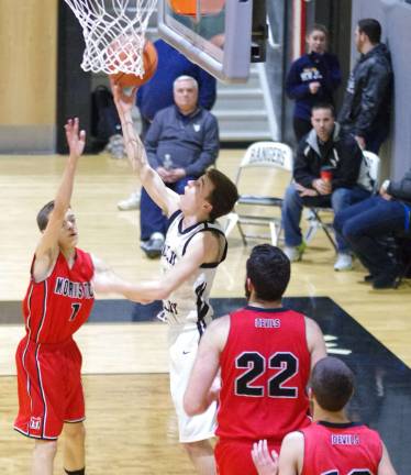 Morris Tech's Mike Volchko attempts to block the shot of Wallkill Valley's Bryce Falk.