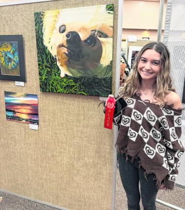 Kayley Pignataro is shown with her second-place ribbon and painting.
