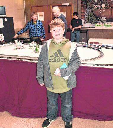Elygh Voughan of Branchville stands in front of a train display.