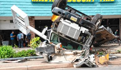 SA1 A truck is overturned Saturday, May 3 in front of Mavis Tire on Main Street in Sparta. Main Street was closed after the accident about 12:45 p.m. The driver was not seriously hurt. (Photo by Nancy Madacsi)
