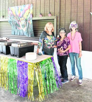 Ann Fisher of Montague, Lyta Soto and Jackie Olsen of Franklin stand by the food table.