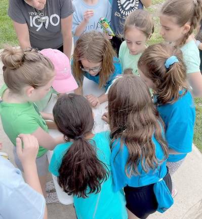 Girls in the Brownies troop play a puzzle game.