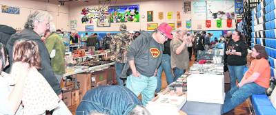 Visitors peruse the tables at the train show.