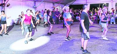<b>Dancers participate in the line dancing competition.</b>
