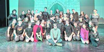 The cast of Shrek is shown with Christopher Sieber, who originated the role of Lord Farquaad on Broadway.